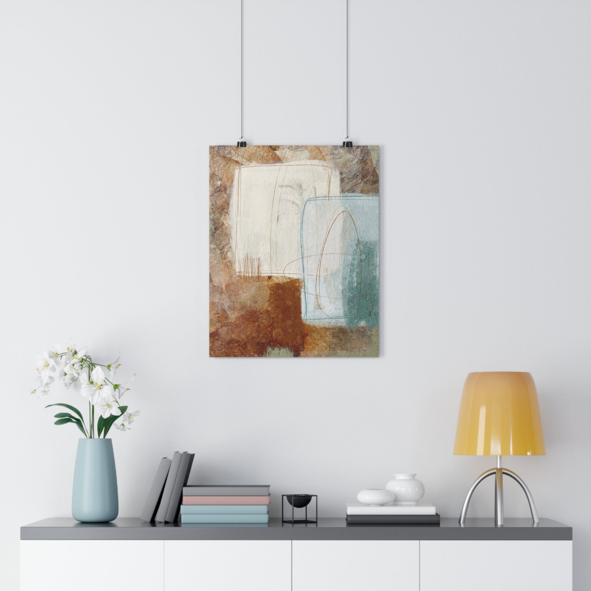 Abstract art print on a white wall above a table with decor items by spektralmuse